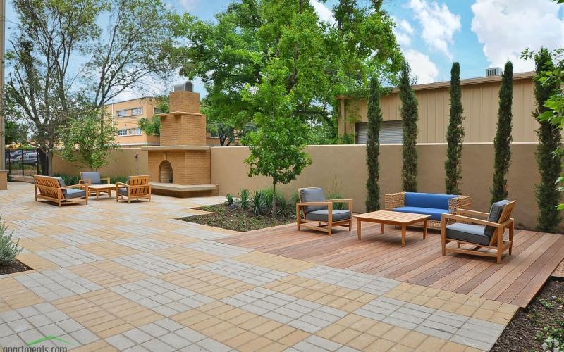 a brick patio with chairs and tables
